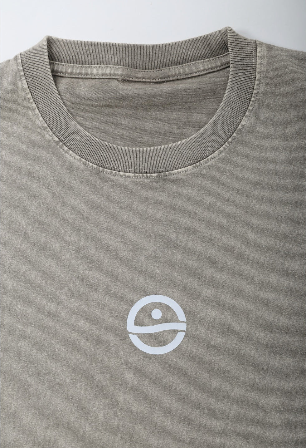 Gray t-shirt with a white logo on a light gray background