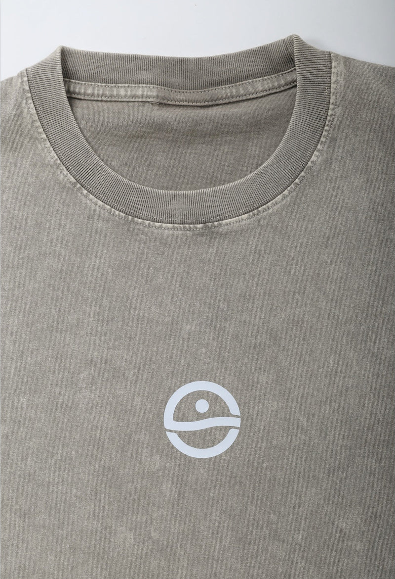 Gray t-shirt with a white logo on a light gray background