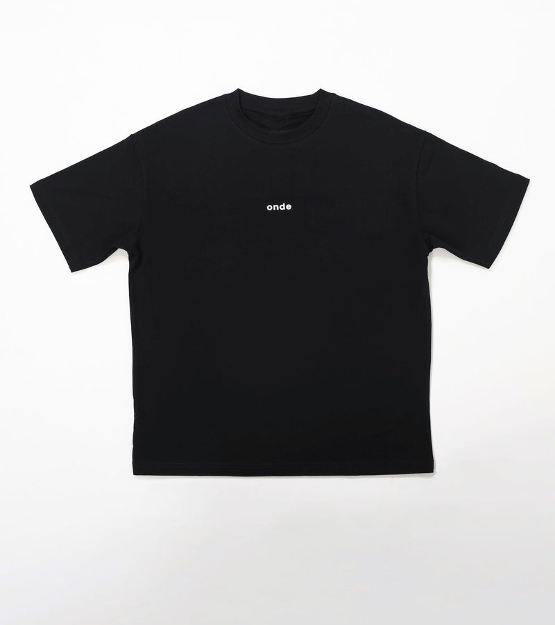Black t-shirt with a small white logo on a white background